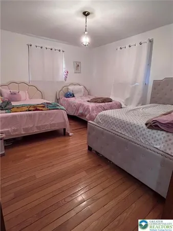 a bedroom with bed and a chandelier
