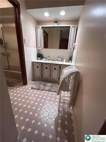 a bathroom with a sink and mirror