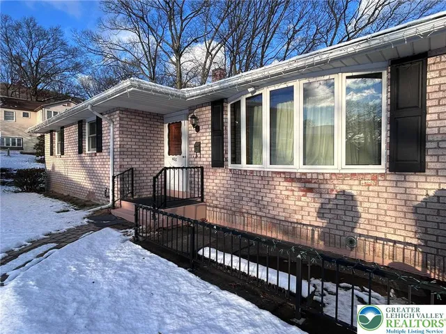 a view of a house with wooden fence