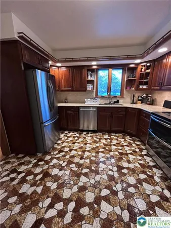 a large kitchen with a stove and a refrigerator