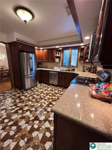 a kitchen with refrigerator and window