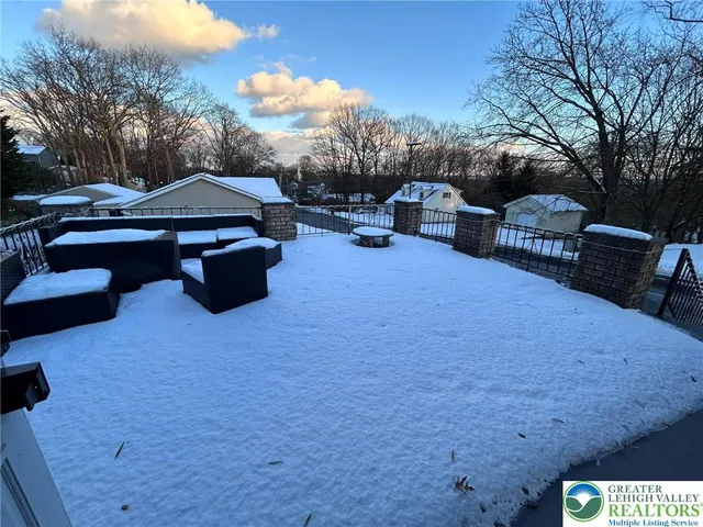 a roof deck with table and chairs under an umbrella