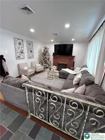 a living room with furniture and a flat screen tv