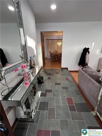 a view of a hallway with workspace and a window