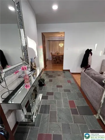 a view of a hallway with workspace and a window