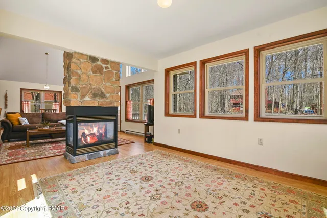 a living room with furniture a rug and a window