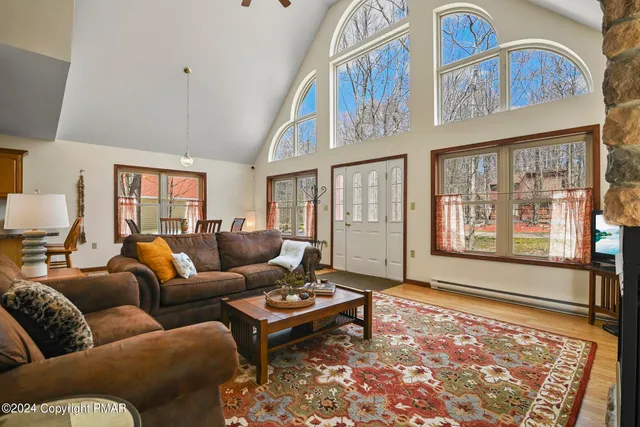 a living room with furniture ceiling fan and a rug