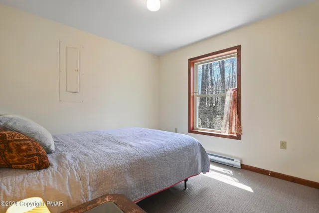 a bedroom with a bed and window