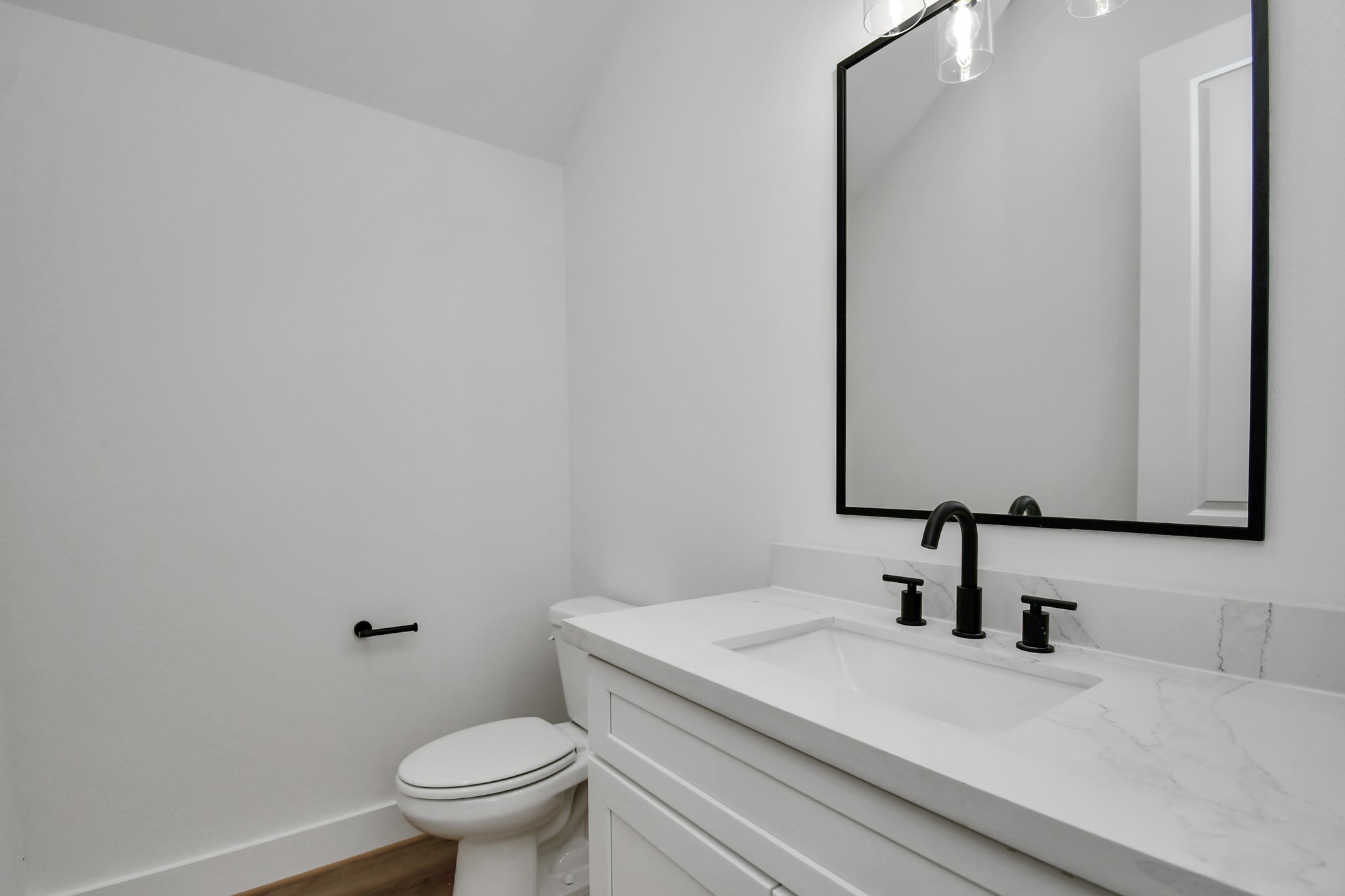 2610 Vance Street Houston, TX 77093 - Photo 13 of 30 a bathroom with a sink a toilet and mirror