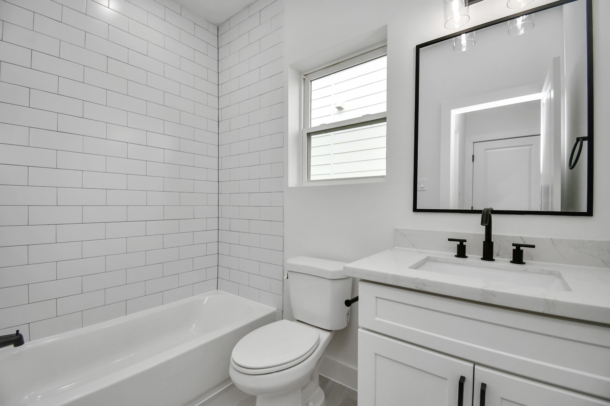 2610 Vance Street Houston, TX 77093 - Photo 26 of 30 a bathroom with a toilet a sink a mirror and bathtub