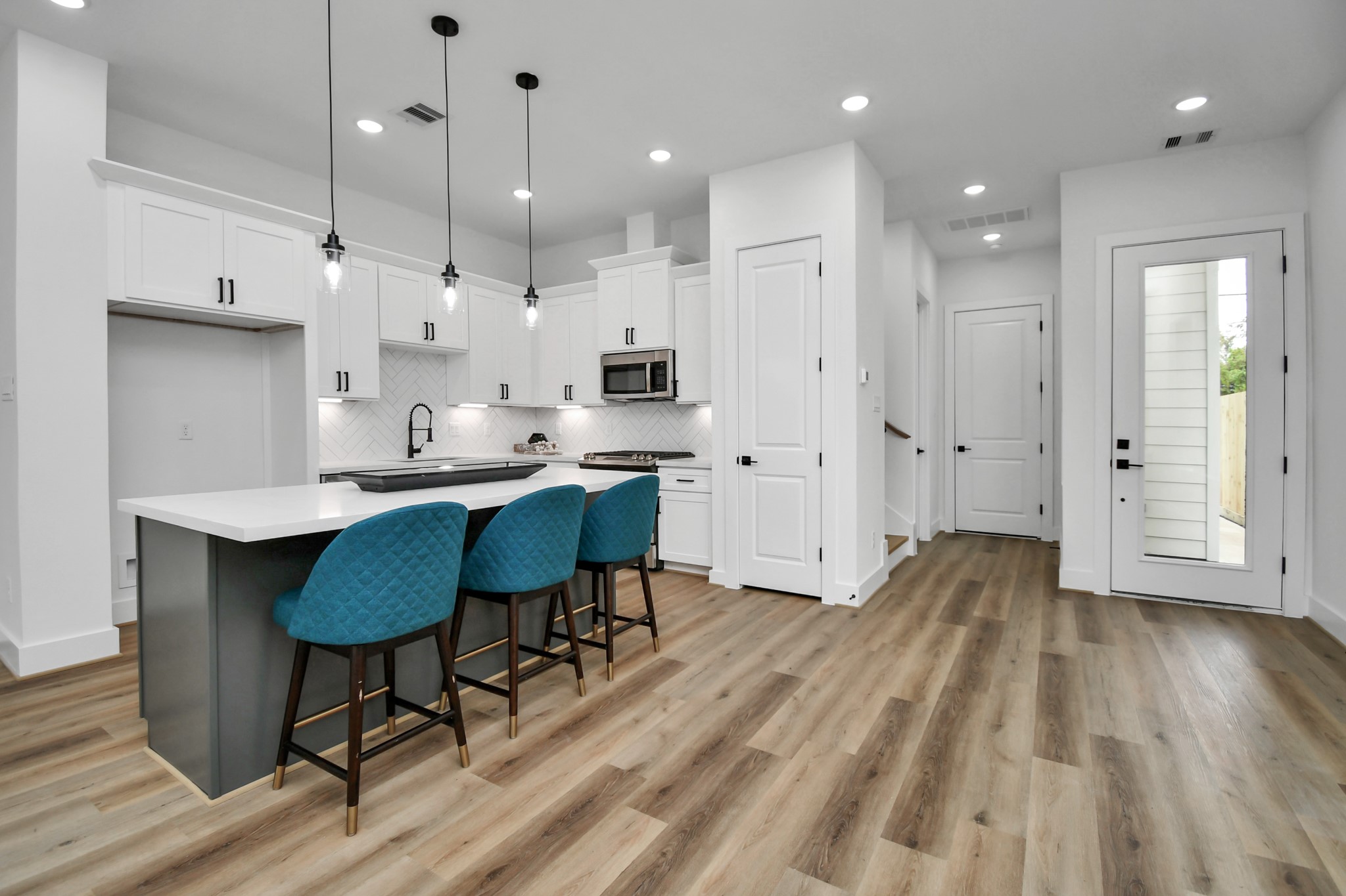 2610 Vance Street Houston, TX 77093 - Photo 6 of 30 a large kitchen with cabinets wooden floor white stainless steel appliances and view living room
