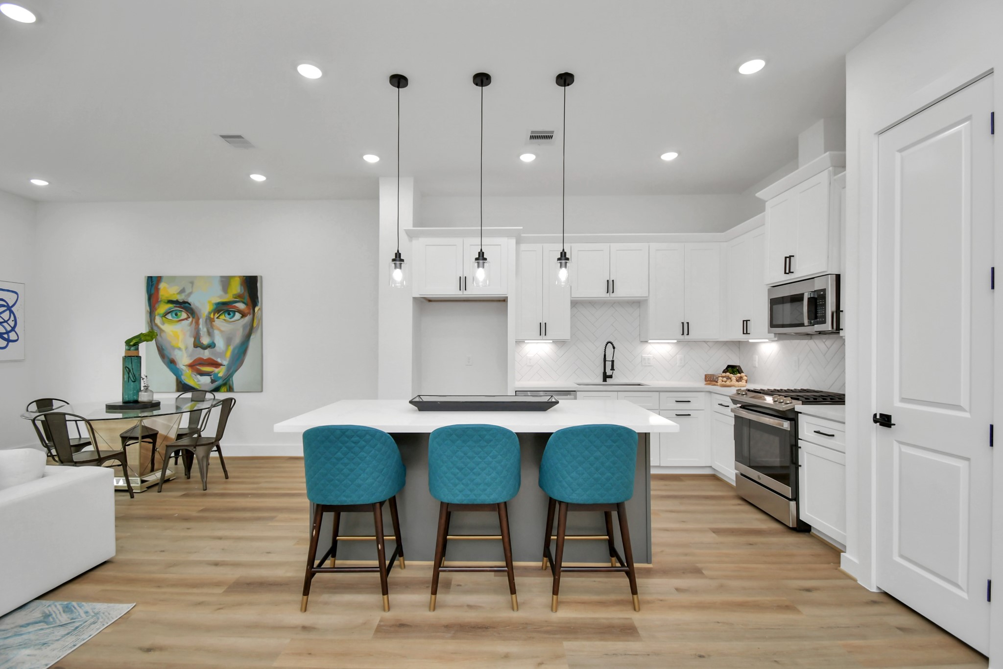 2610 Vance Street Houston, TX 77093 - Photo 7 of 30 a large kitchen with kitchen island a dining table chairs and white cabinets