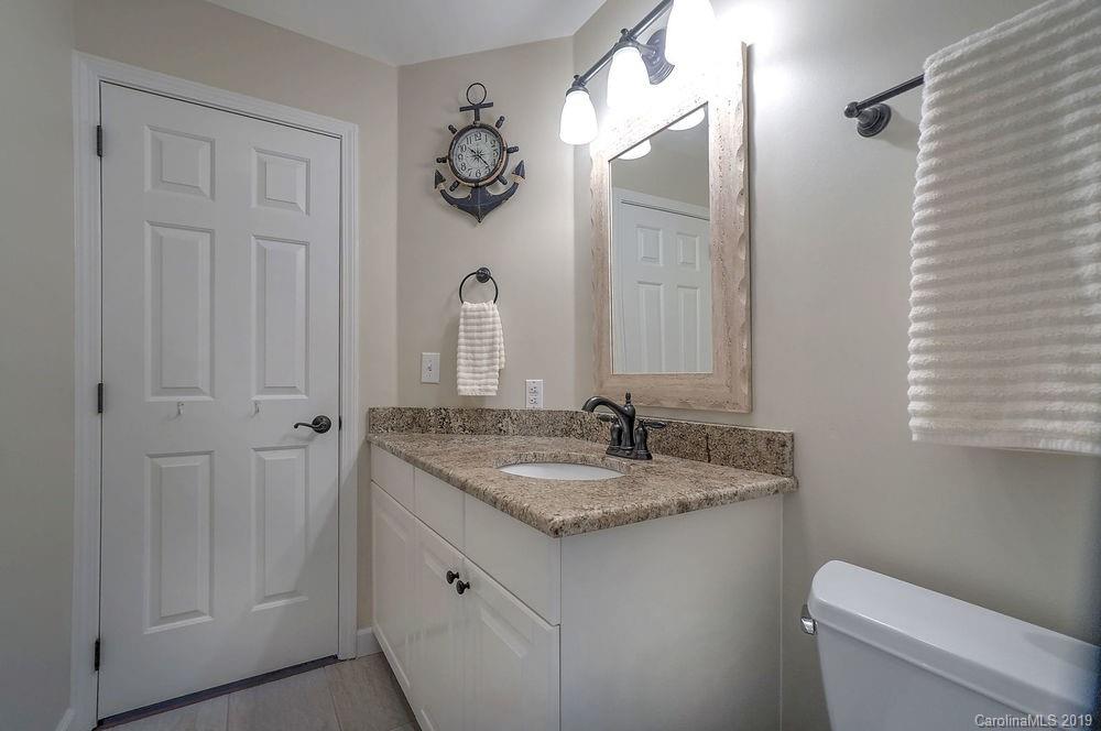 1133 Torrence Circle Davidson, NC 28036 - Photo 11 of 25 a bathroom with a granite countertop sink and a mirror
