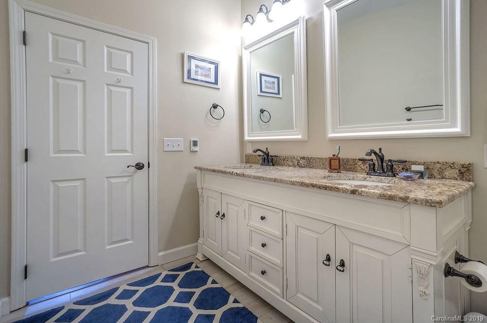 1133 Torrence Circle Davidson, NC 28036 - Photo 14 of 25 a bathroom with a granite countertop sink and a mirror
