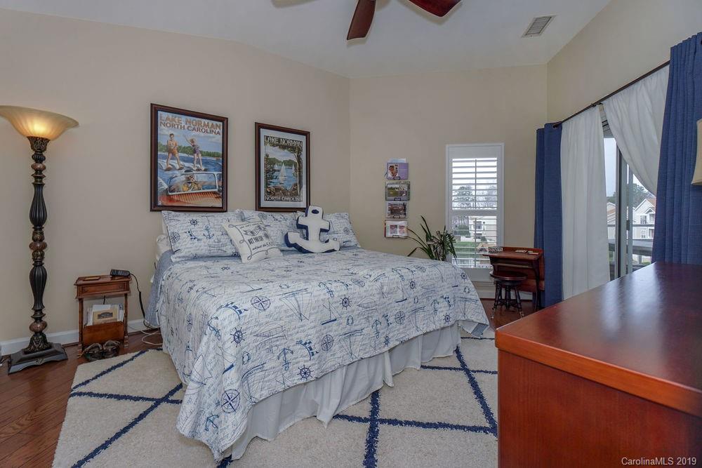 1133 Torrence Circle Davidson, NC 28036 - Photo 15 of 25 a bedroom with a bed and wooden floor