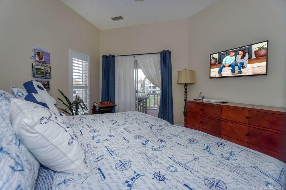 1133 Torrence Circle Davidson, NC 28036 - Photo 16 of 25 a bedroom with a bed and a dresser in it