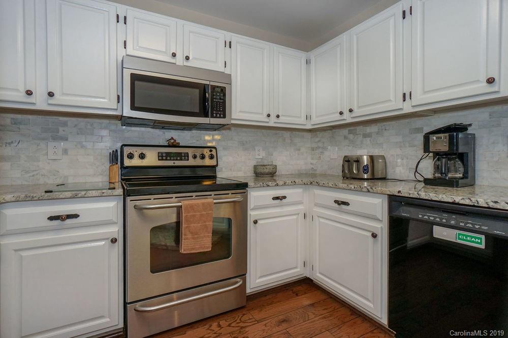 1133 Torrence Circle Davidson, NC 28036 - Photo 3 of 25 a kitchen with cabinets stainless steel appliances a sink and a microwave
