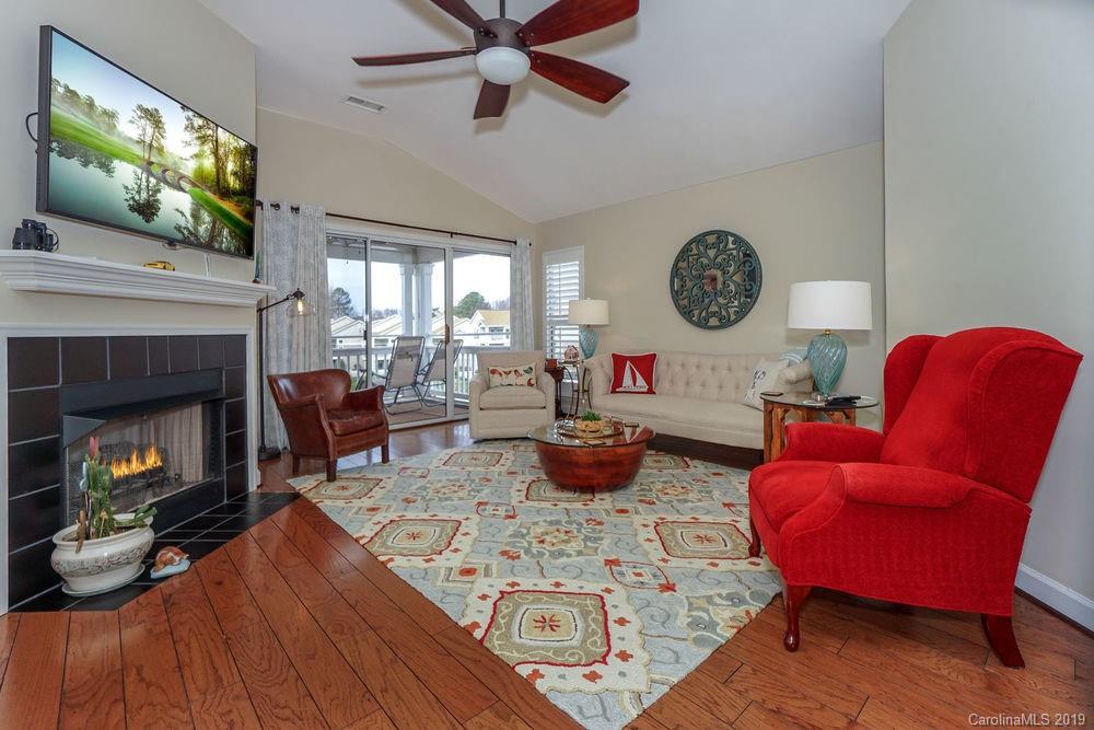 1133 Torrence Circle Davidson, NC 28036 - Photo 5 of 25 a living room with furniture a flat screen tv and a fireplace