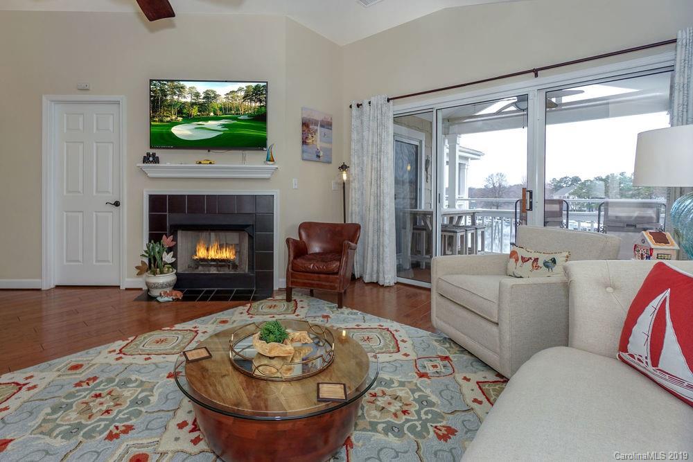 1133 Torrence Circle Davidson, NC 28036 - Photo 6 of 25 a living room with furniture a flat screen tv and a fireplace