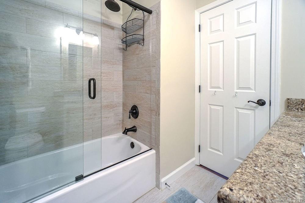 1133 Torrence Circle Davidson, NC 28036 - Photo 9 of 25 a bathroom with a bathtub and shower