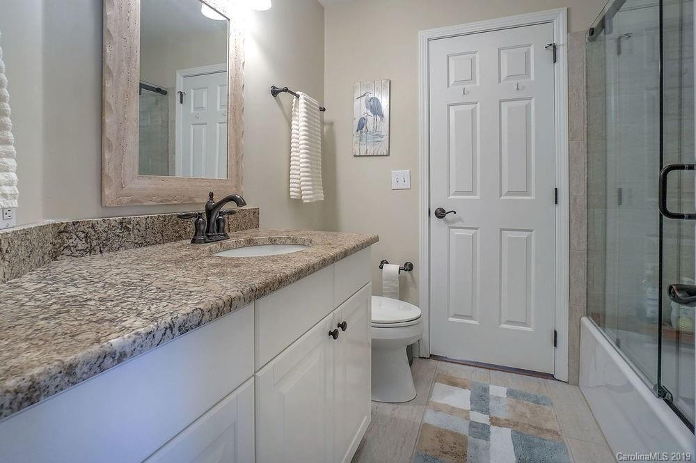 1133 Torrence Circle Davidson, NC 28036 - Photo 10 of 25 a bathroom with a granite countertop sink and a mirror