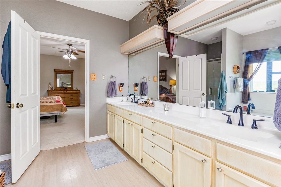 345 Trail Ridge Drive Sandia, TX 78383 - Photo 30 of 40 a en suite bathroom with a sink and a mirror
