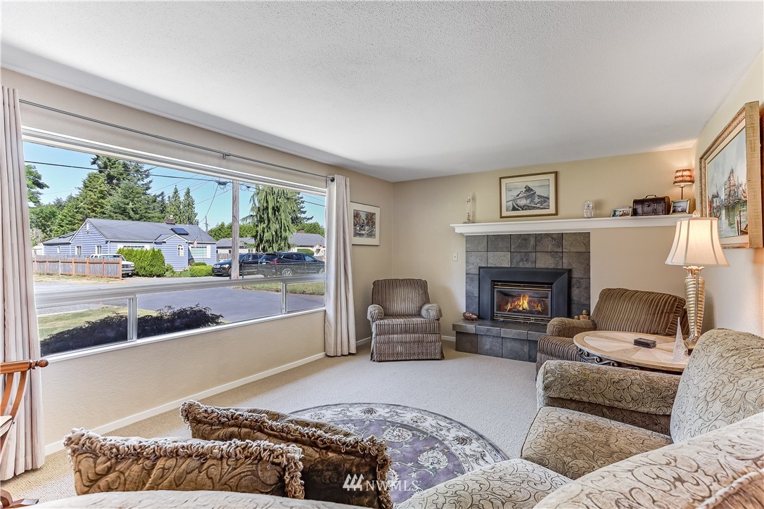 7007 Carson Road Everett, WA 98203 - Photo 3 of 24 a living room with furniture and a fireplace