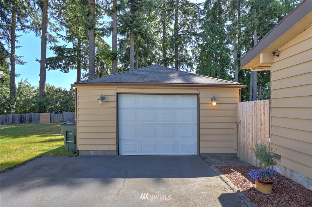 7007 Carson Road Everett, WA 98203 - Photo 22 of 24 a view of a backyard with plants and large tree