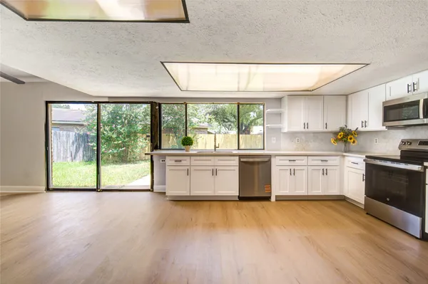a kitchen with a stove a sink and a microwave