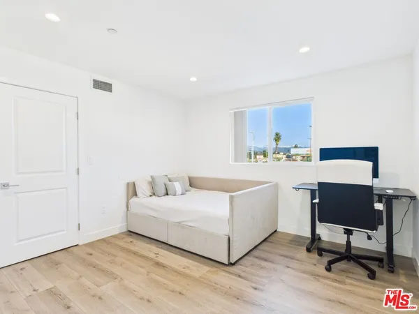 a room with a bed a desk and chair