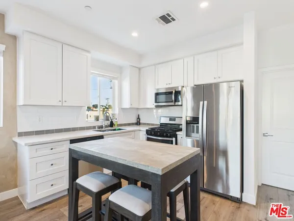a kitchen with a refrigerator a stove a sink and a refrigerator
