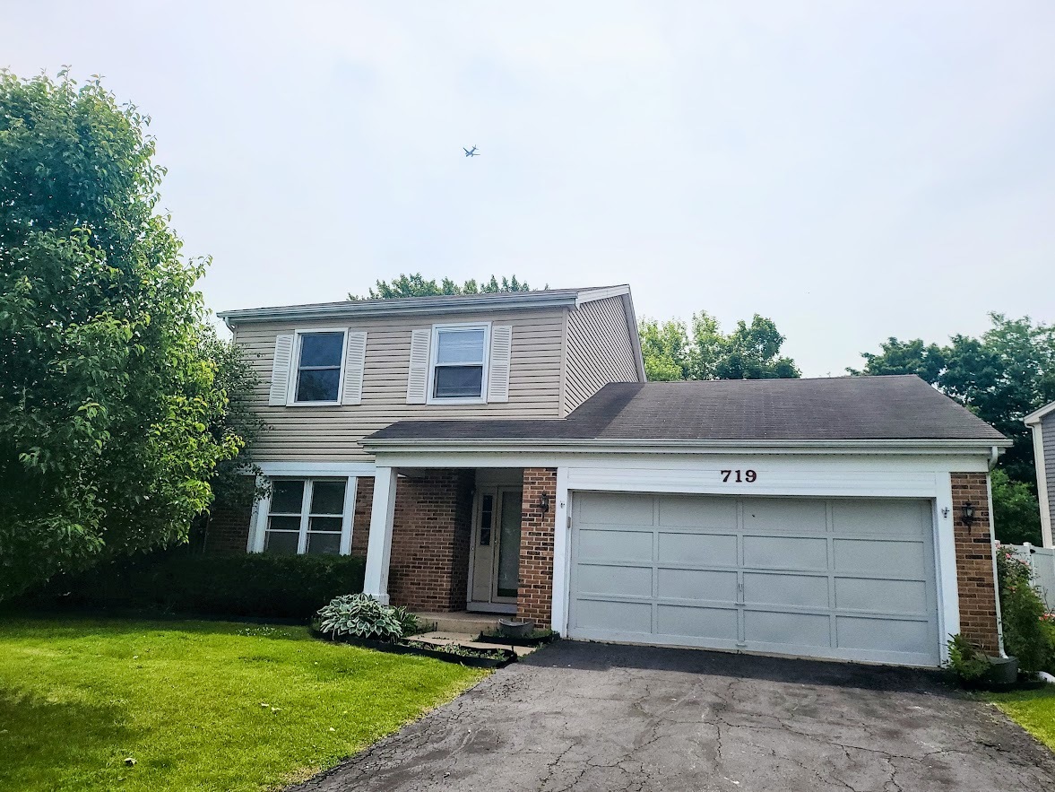 719 Radnor Drive Roselle, IL 60172 - Photo 1 of 18 a front view of a house with a yard