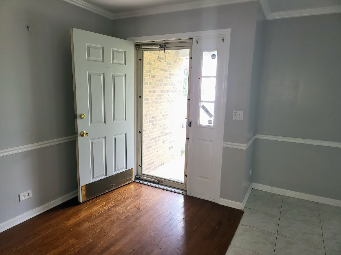 719 Radnor Drive Roselle, IL 60172 - Photo 2 of 18 an empty room with wooden floor and windows