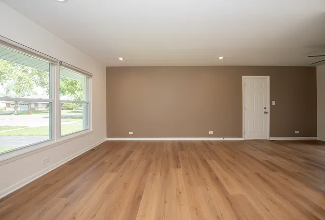 wooden floor in an empty room with a window