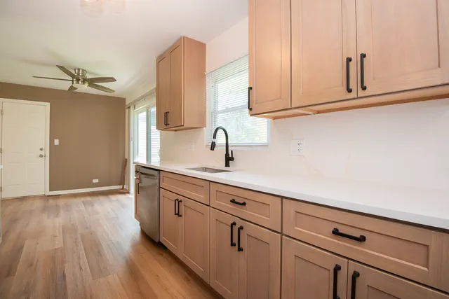a kitchen with sink and cabinets