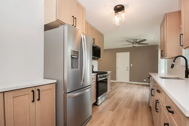 a kitchen with a refrigerator a sink and dishwasher