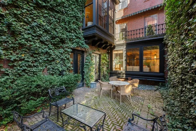 a living room with furniture a dining table and a fireplace