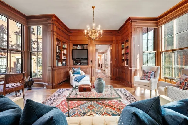 a living room with furniture and a chandelier