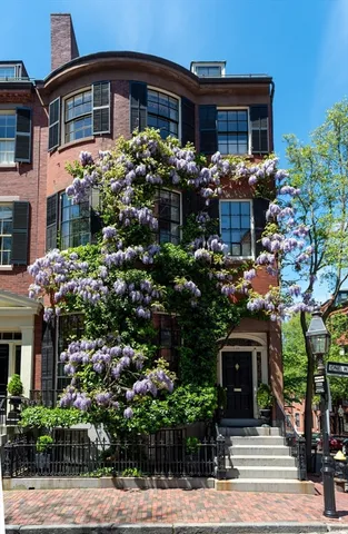 a living room with furniture a fireplace and a window