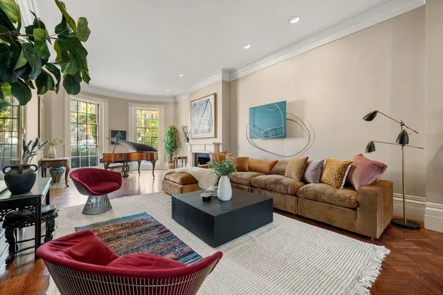 a living room with furniture or chandelier and a wooden floor