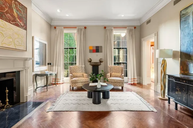 a dining room with furniture window and wooden floor