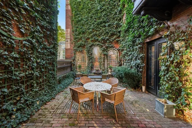 a living room with furniture a bookshelf and a large window