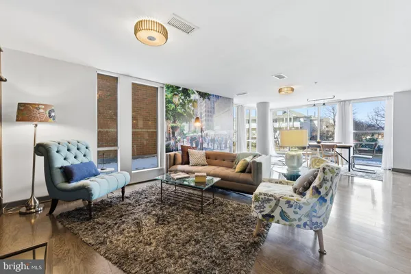 a large living room with stainless steel appliances granite countertop a couch and a view of living room