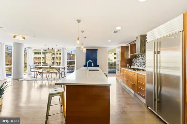 a large kitchen with a table and chairs