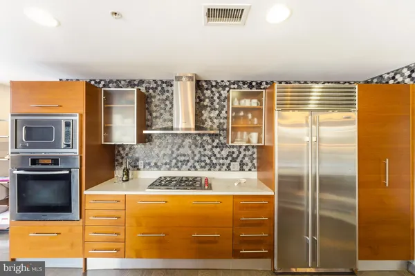 a large kitchen with a table and chairs