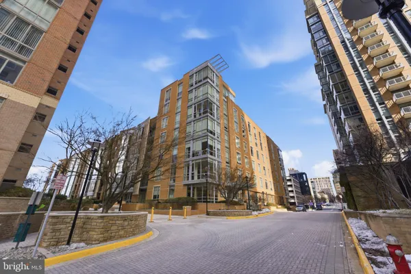 a view of a hallway with furniture and wooden floor