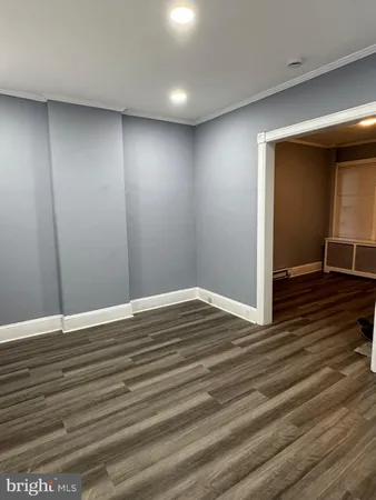 a view of room with wooden floor
