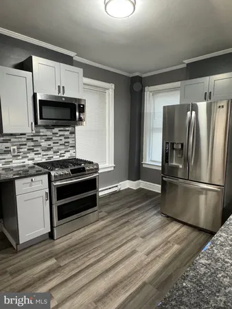 a kitchen with stainless steel appliances a refrigerator stove and microwave