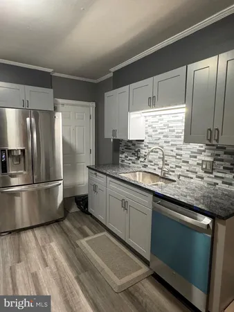 a kitchen with stainless steel appliances a refrigerator sink and microwave