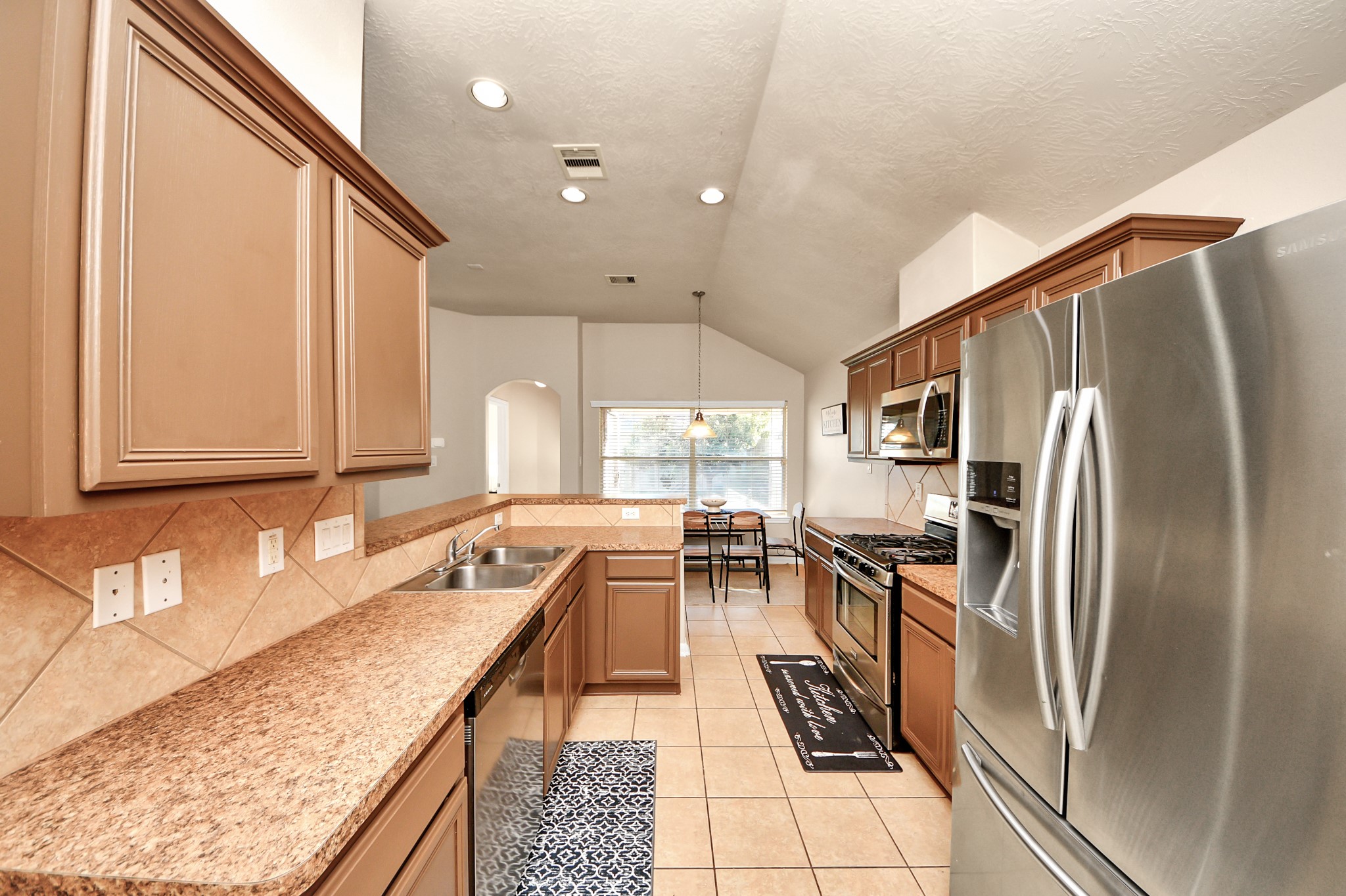 13342 South Point Lane Houston, TX 77034 - Photo 10 of 37 a kitchen with granite countertop lots of counter top space and stainless steel appliances